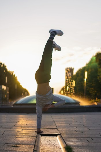 Person Doing Handstand Near Fountain