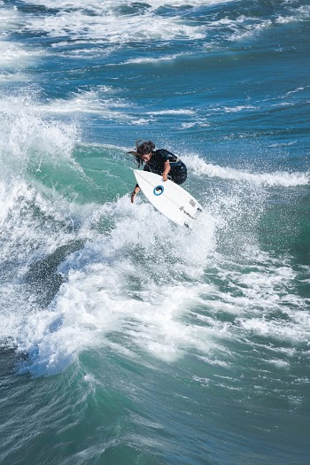 Person Doing Stunt on Surfboard