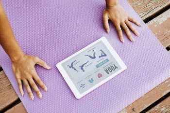 Person Doing Yoga While Looking at Silver Ipad