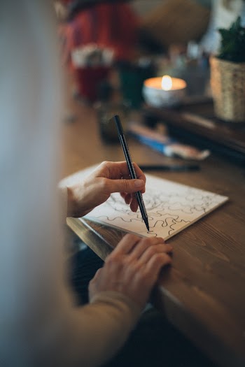 Person Drawing on Paper