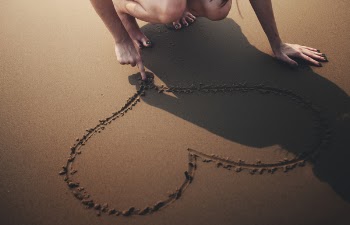 Person Draws Heart on Sand