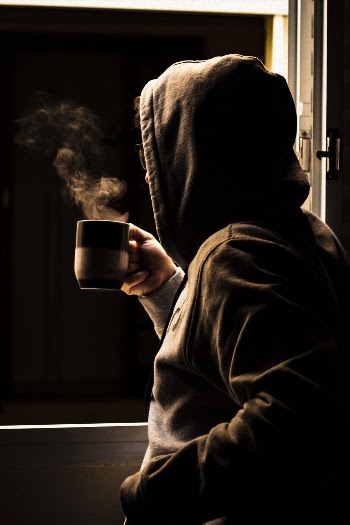 Person Drinking Coffee Next to Window
