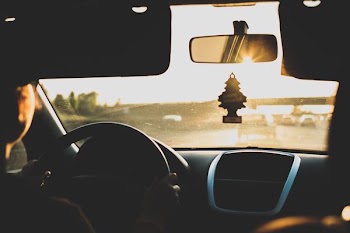 person driving car during daytime