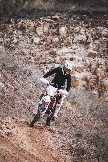 Person Driving Motocross Dirt Bike Outdoors