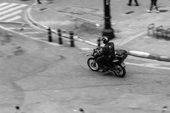 Person Driving Motorcycle Near Post and People