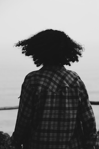 Person Facing the Ocean during Day