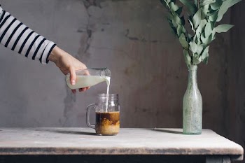 person filling milk on glass