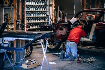 person fixing car