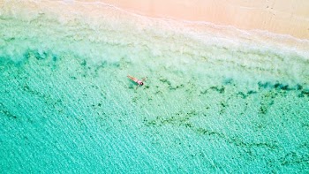person floating on body of water