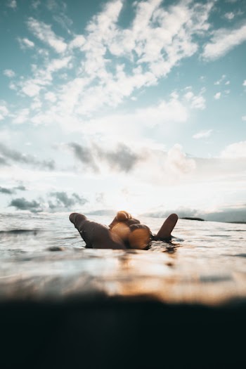 Person Floating on Water at Daytime