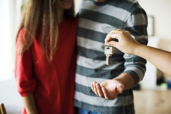 Person Giving Keys on Man