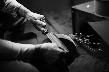 person grinding cleaver