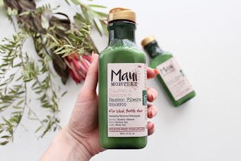 person h olding Maui moisture bottle