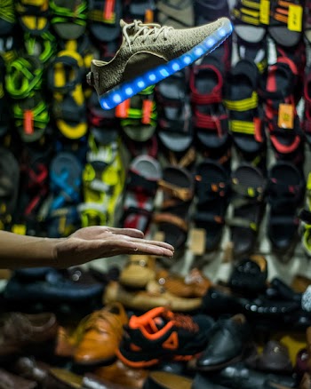 Person Hand Near Assorted Footwear