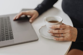 Person Having Tea While Working