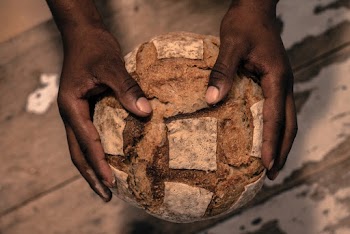 Person Holding A Bread