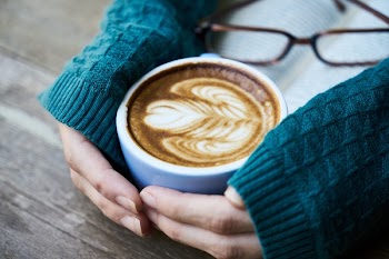 Person Holding a Cup of Latte