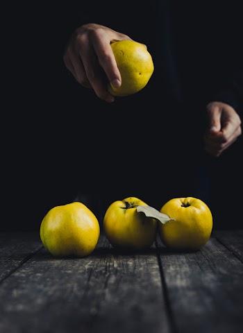 Person Holding a Green Apple