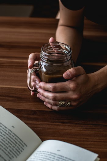 Person Holding a Mason Jar 