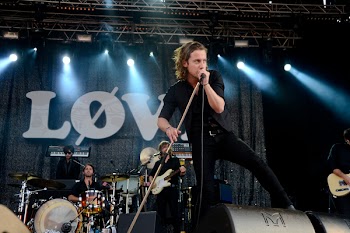 Person Holding a Microphone While Singing at Stage