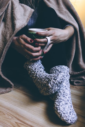 Person Holding A Mug