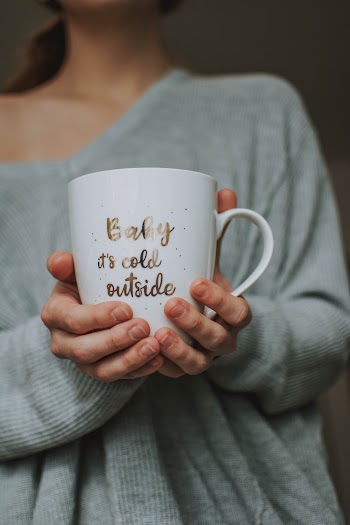 Person Holding A Mug