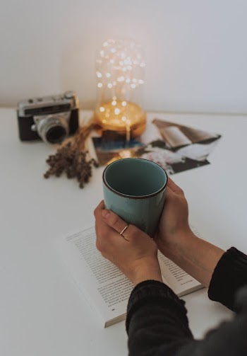 Person Holding A Mug