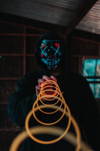 Person Holding a Plastic Spring Close-up Photography