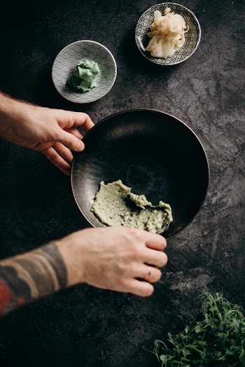 Person Holding a Round Black Plate With Food
