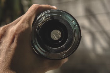 Person Holding a Round Gray Steel Tool