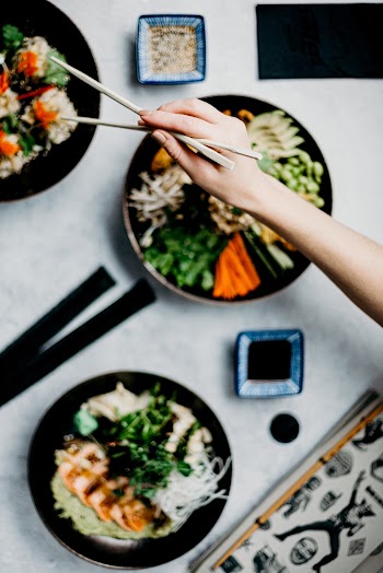 Person Holding A Wooden Chopsticks