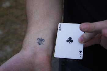 Person Holding Ace of Club Playing Card