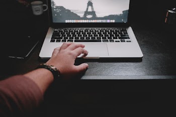 Person Holding Apple Macbook Pro