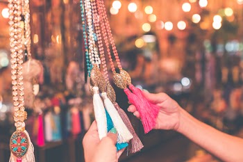 Person Holding Assorted-colored Tassel Necklace Lot