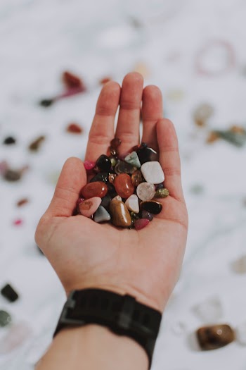 Person Holding Assorted Pebbles