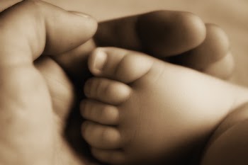 Person Holding Baby's Foot