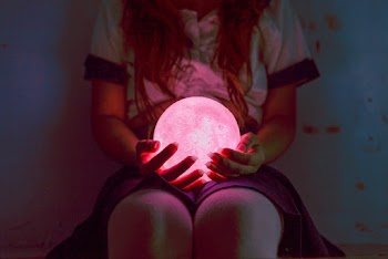 Person Holding Ball Night Lamp While Sitting