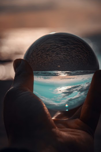 Person Holding Ball Showing Seashore