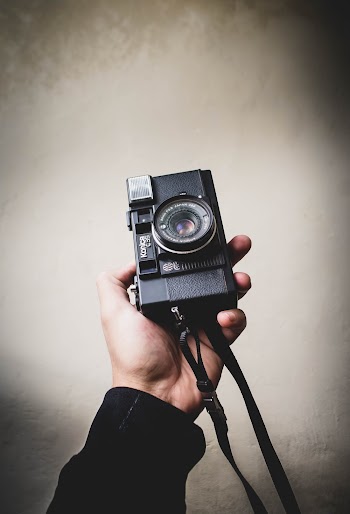 Person Holding Black Analog Camera