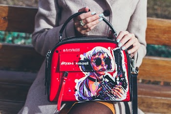 Person Holding Black And Red Leather Shoulder Bag