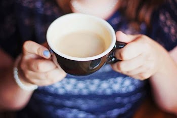 Person Holding Black and White Ceramic Mug