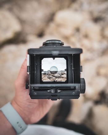 person holding black camera
