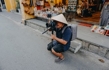 Person Holding Black Camera Close-up Photography