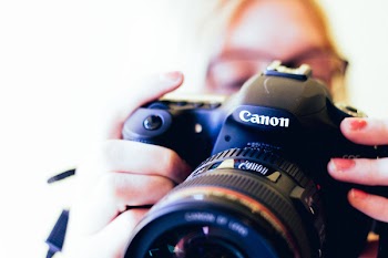 Person Holding Black Canon Dslr Camera