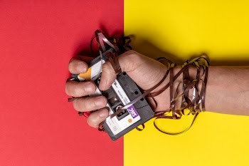 Person Holding Black Cassette Tape