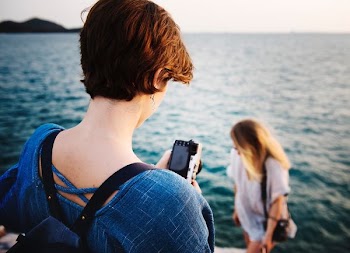 person holding black digital camera