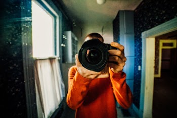 Person Holding Black Dlsr Camera