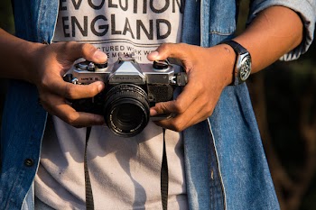Person Holding Black Dslr Camera