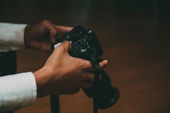 person holding black DSLR camera