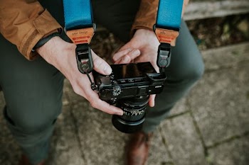 person holding black DSLR camera